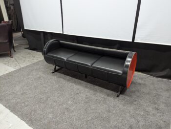 Black leather 3-seater sofa with unique red side panels and modern design, perfect for contemporary living rooms. Refurbished and available in Northern Ireland from Maria Furniture Ltd.