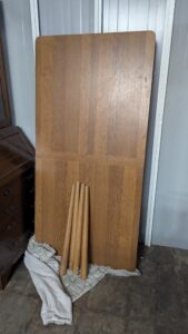 Extended oak dining table, solid wood with leaf extension, versatile and stylish for dining rooms.