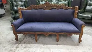 Blue antique wingback 3-seater sofa, refurbished, vintage style, elegant wooden frame.