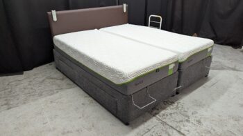 Comfortable sofa bed with grey fabric and spacious storage drawers, ideal for guest rooms or small living spaces in Northern Ireland.