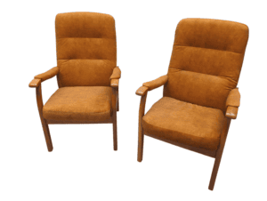 Vintage brown armchairs with wooden armrests and legs.