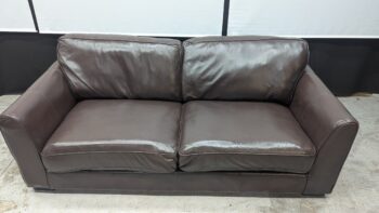 Two-seater leather sofa in rich brown with sleek design.