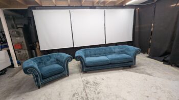 Elegant blue velvet 2 and 3-seater sofas with classic rolled arms and tufted backrests. Perfect for stylish living rooms, refurbished by Maria Furniture Ltd in Northern Ireland.