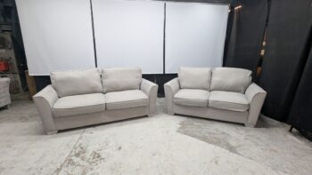 Modern beige 3-seater sofas in showroom.