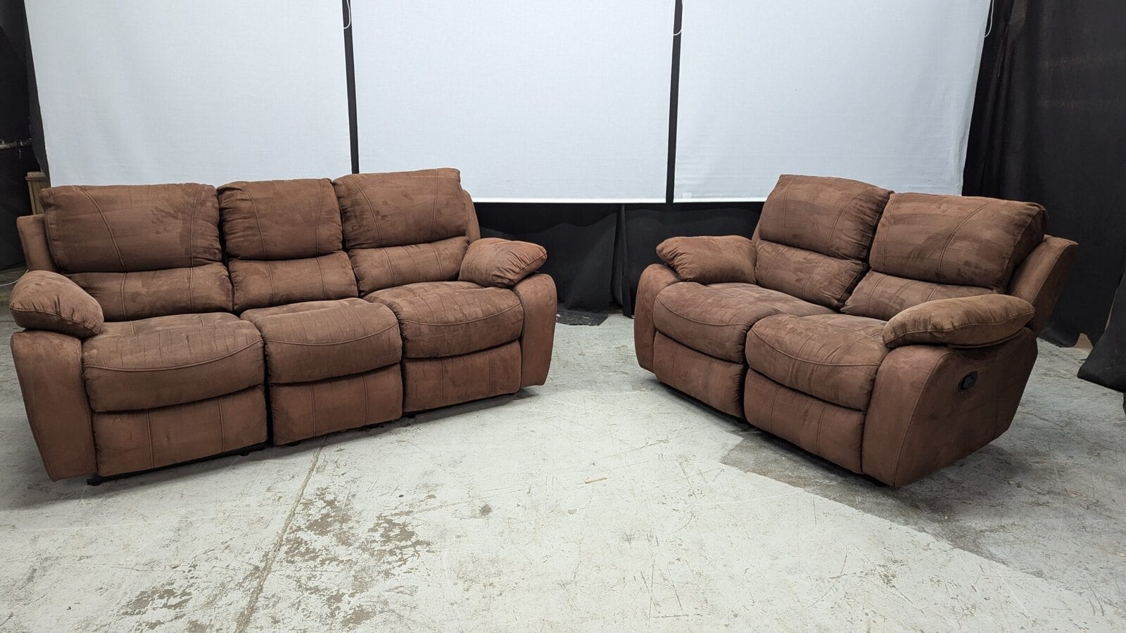 Comfortable brown fabric 3-seater sofa and armchair Brown fabric 3-seater sofa and armchair, plush style, in a showroom setting.