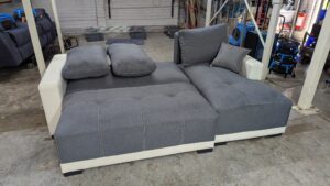 Modern grey corner sofa with white accents